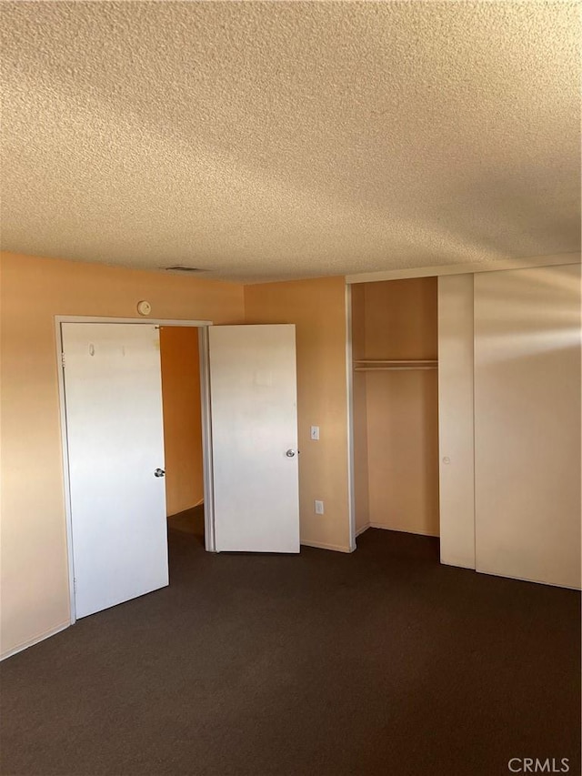 26873 Mossway St, Highland, CA 92346 - unfurnished bedroom featuring dark carpet, a closet, and a textured ceiling