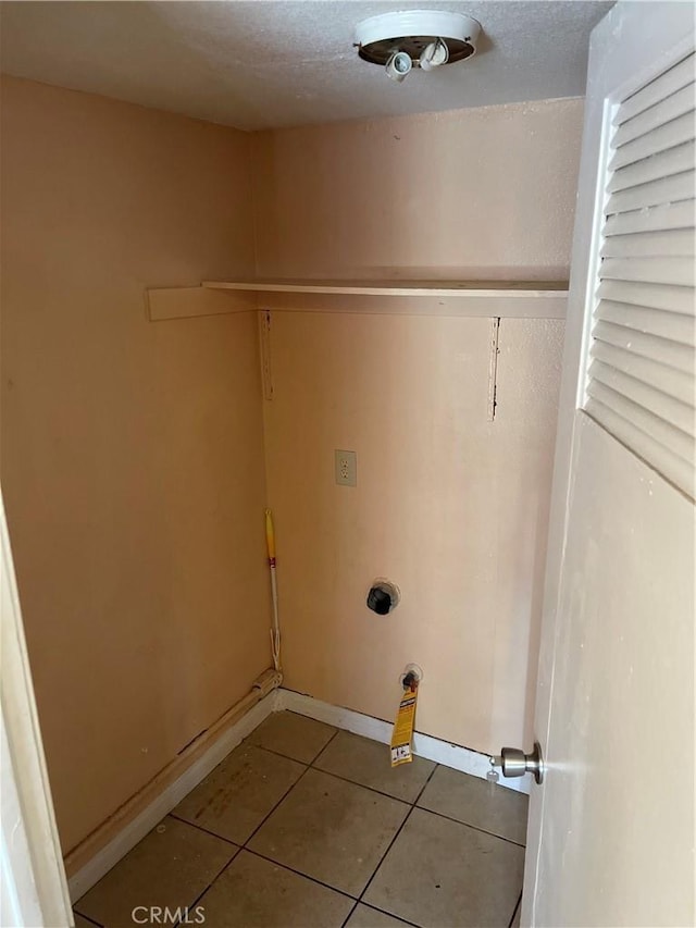 26873 Mossway St, Highland, CA 92346 - laundry room featuring baseboards, tile patterned flooring, laundry area, and a textured ceiling