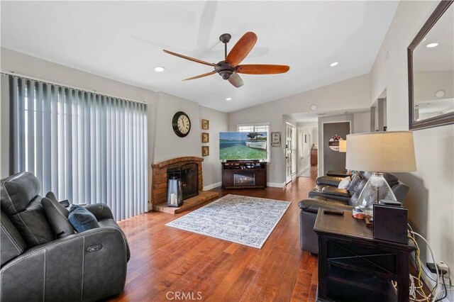 805 W Brentwood Ave, Orange, CA 92865 - living room featuring a ceiling fan, wood finished floors, a fireplace with raised hearth, vaulted ceiling, and recessed lighting