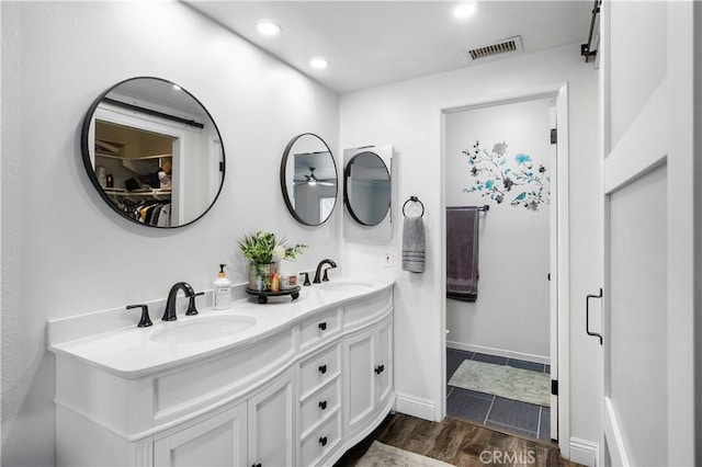 805 W Brentwood Ave, Orange, CA 92865 - full bathroom with double vanity, recessed lighting, wood finished floors, and a walk in closet