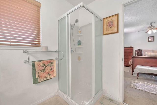 6087 Academy Ave, Riverside, CA 92506 - ensuite bathroom featuring baseboards, a stall shower, ensuite bath, a textured ceiling, and a ceiling fan