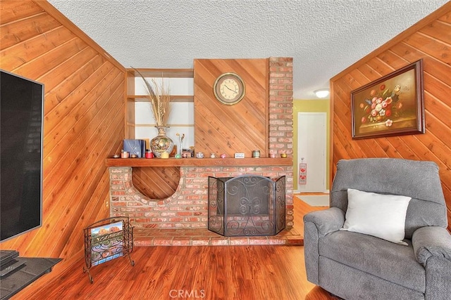 6087 Academy Ave, Riverside, CA 92506 - living room with wooden walls, a textured ceiling, and wood finished floors
