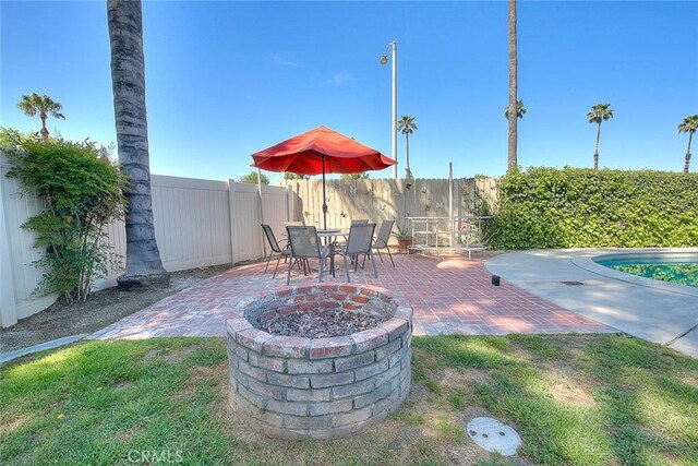 6087 Academy Ave, Riverside, CA 92506 - view of patio / terrace with a fenced backyard and an outdoor fire pit
