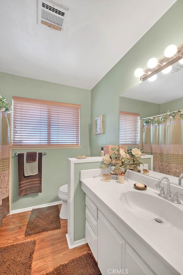 6087 Academy Ave, Riverside, CA 92506 - bathroom featuring vanity, baseboards, toilet, visible vents, and wood finished floors