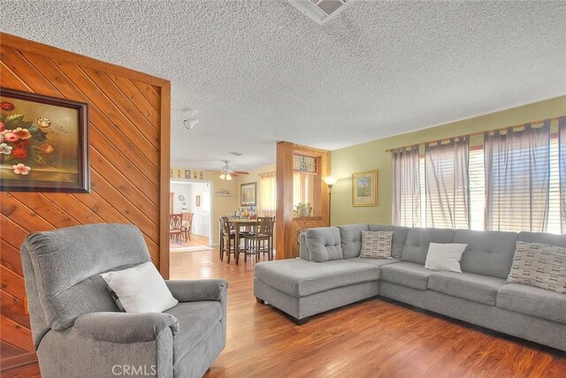 6087 Academy Ave, Riverside, CA 92506 - living area featuring a textured ceiling, wood finished floors, a ceiling fan, and visible vents