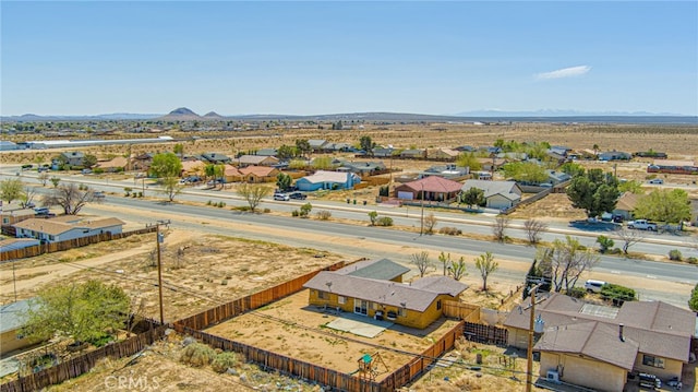 birds eye view of property with a mountain view and view of desert