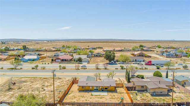 drone / aerial view featuring a mountain view, a residential view, and view of desert