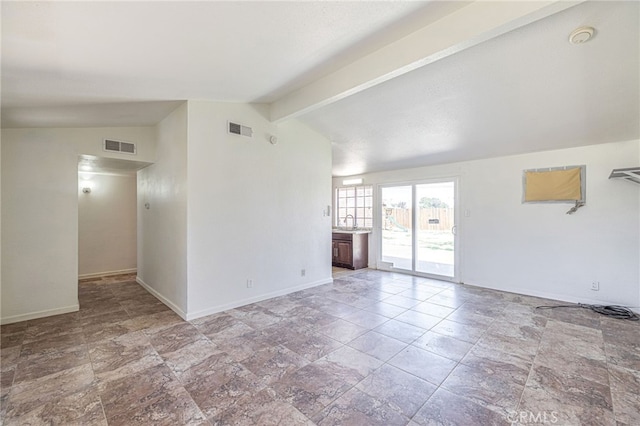 unfurnished living room with a sink, baseboards, vaulted ceiling with beams, and visible vents