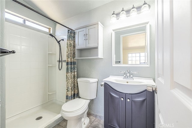 full bath with tile patterned floors, vanity, a stall shower, and toilet