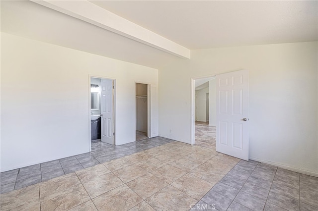 spare room with lofted ceiling with beams