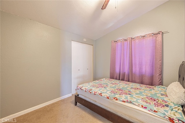 carpeted bedroom featuring baseboards, a ceiling fan, vaulted ceiling, and a textured ceiling