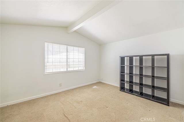unfurnished room featuring baseboards, vaulted ceiling with beams, and carpet floors