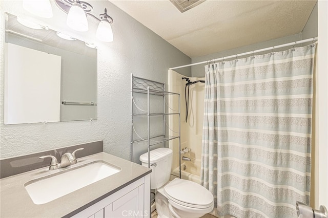 full bath with visible vents, toilet, shower / tub combo with curtain, a textured wall, and vanity