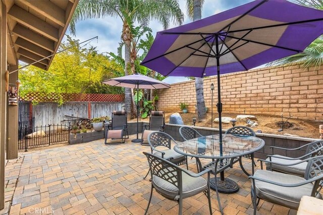 29567 Cool Meadow Dr, Menifee, CA 92584 - fenced backyard with a patio area and outdoor dining space
