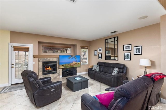 29567 Cool Meadow Dr, Menifee, CA 92584 - living room featuring light tile patterned floors, healthy amount of natural light, and a tiled fireplace