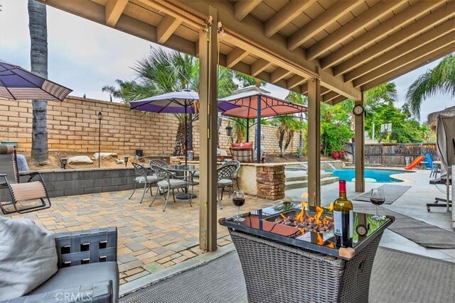 29567 Cool Meadow Dr, Menifee, CA 92584 - fenced backyard featuring a fire pit, a gazebo, outdoor dining space, and a patio