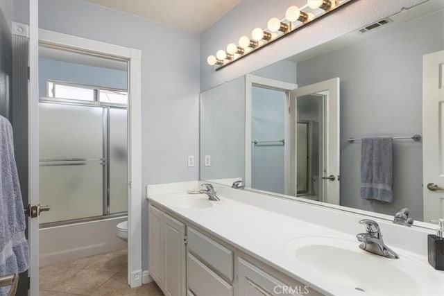 29567 Cool Meadow Dr, Menifee, CA 92584 - bathroom featuring double vanity, bath / shower combo with glass door, and tile patterned flooring
