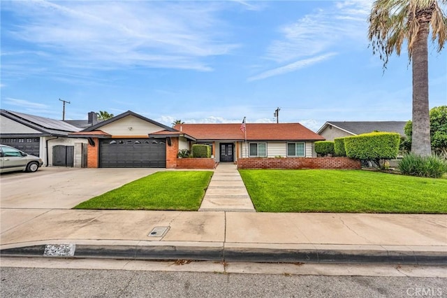12195 Monte Vista Ave, Chino, CA 91710 - view of front of house featuring brick siding, driveway, a front lawn, and a garage