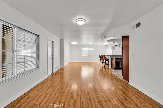 12195 Monte Vista Ave, Chino, CA 91710 - unfurnished living room with light wood-type flooring, baseboards, and visible vents