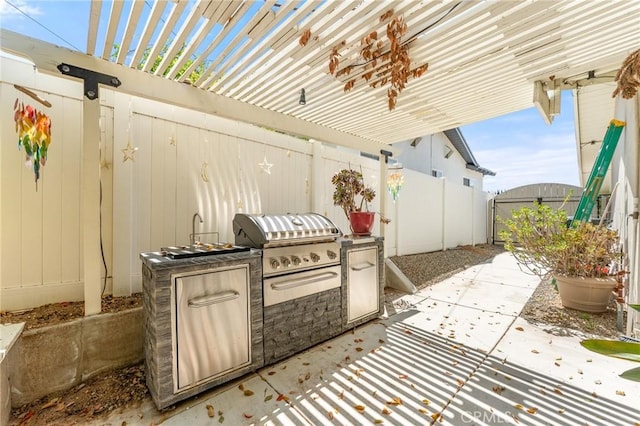 view of patio / terrace featuring a grill, an outdoor kitchen, a pergola, and fence