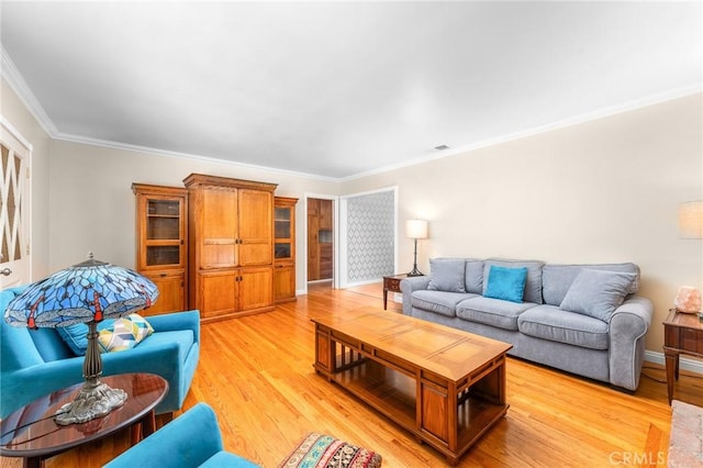 living room with crown molding and light wood finished floors
