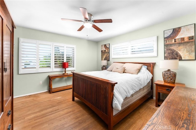 bedroom with baseboards, light wood finished floors, and ceiling fan
