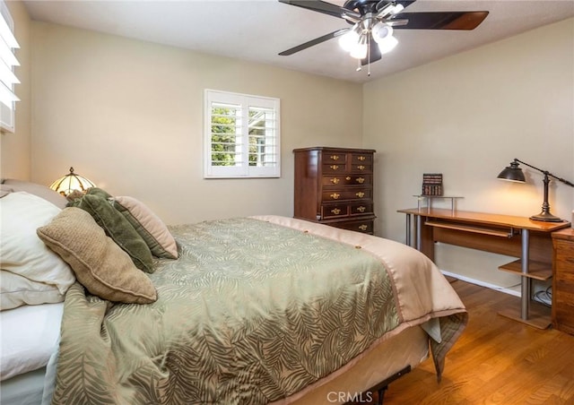bedroom featuring a ceiling fan and wood finished floors