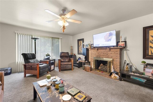 carpeted living room featuring a fireplace and a ceiling fan
