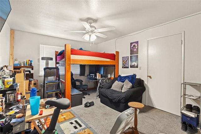 bedroom featuring a ceiling fan and carpet