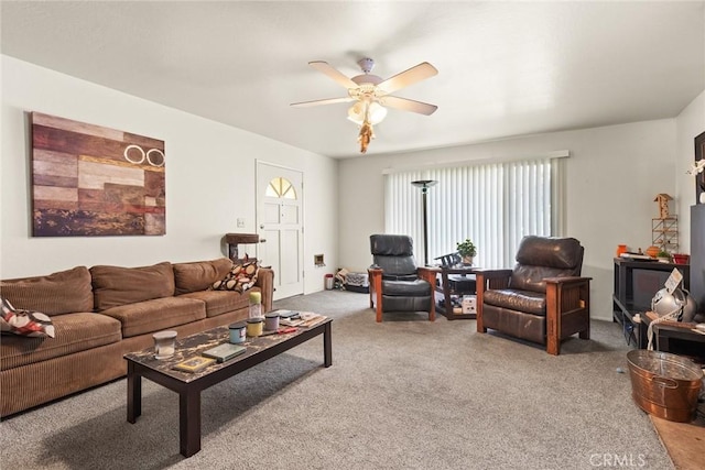 carpeted living area featuring a ceiling fan