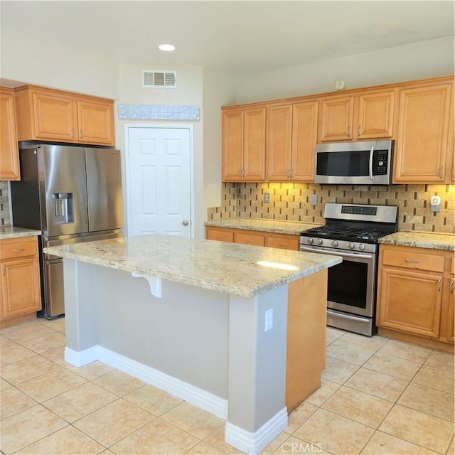 24963 Sunset Vista Ave, Menifee, CA 92584 - kitchen with appliances with stainless steel finishes, a center island, light tile patterned floors, decorative backsplash, and recessed lighting