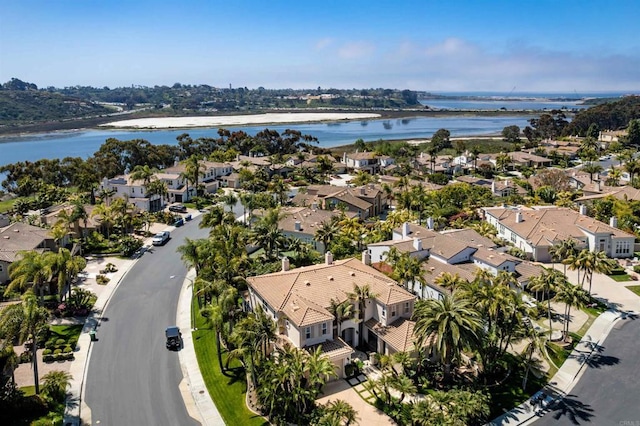 drone / aerial view featuring a water view and a residential view