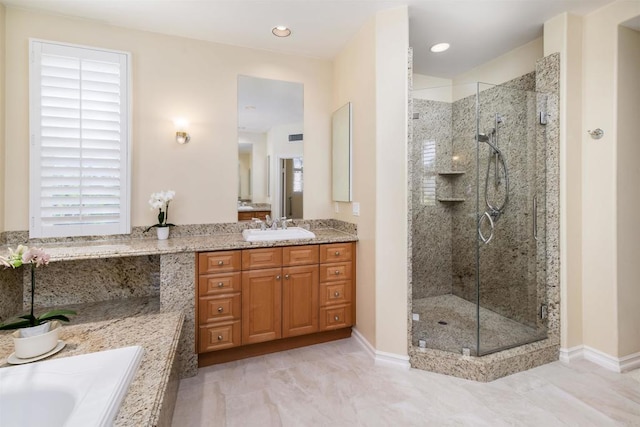 bathroom featuring vanity, a wealth of natural light, a stall shower, and a garden tub