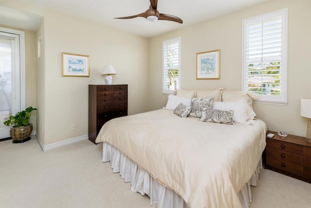 bedroom featuring light carpet, ceiling fan, and baseboards