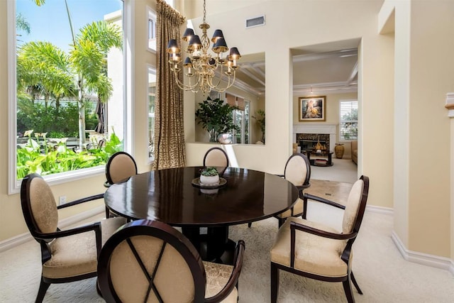 carpeted dining area featuring a fireplace, visible vents, baseboards, and ornamental molding