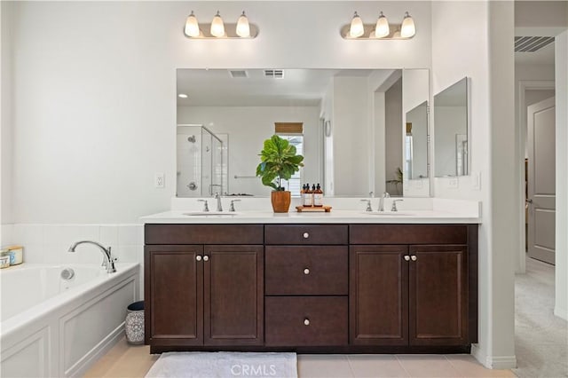 full bathroom with a shower stall, a bath, double vanity, and a sink