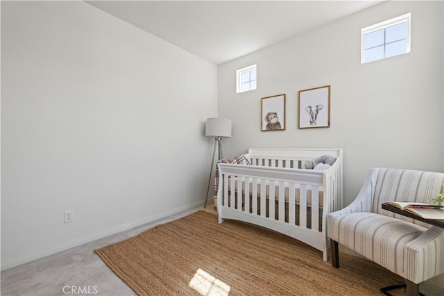bedroom featuring baseboards and carpet