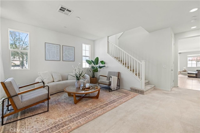 living room featuring visible vents, recessed lighting, carpet flooring, and stairs