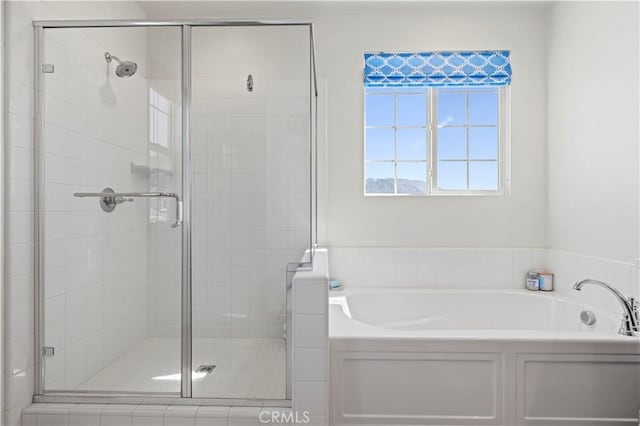 bathroom with a garden tub and a stall shower