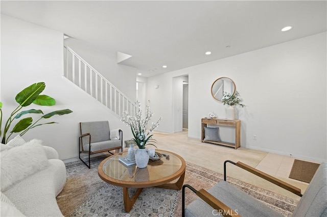 living room featuring recessed lighting, stairs, carpet, and baseboards