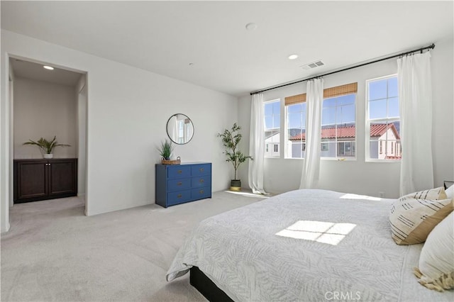 bedroom with visible vents, recessed lighting, and carpet