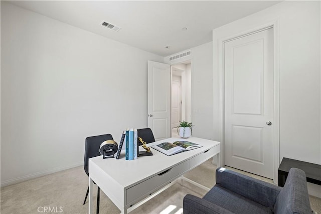 office featuring light colored carpet, baseboards, and visible vents