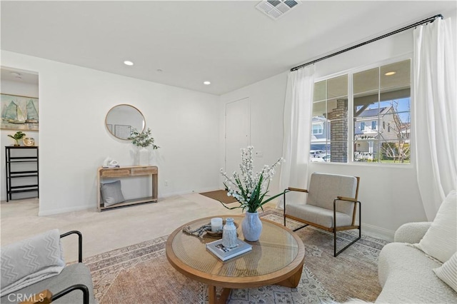 carpeted living room featuring visible vents, baseboards, and recessed lighting
