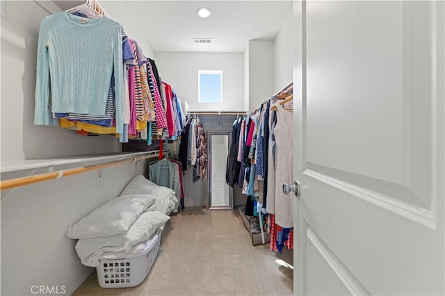 walk in closet with visible vents and carpet floors