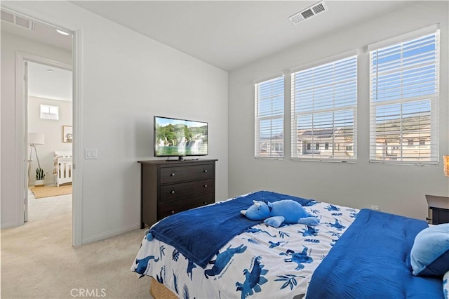 bedroom featuring light carpet, visible vents, and baseboards