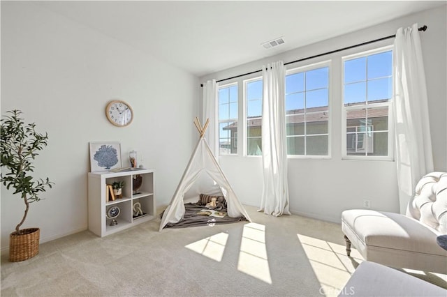 recreation room featuring visible vents, baseboards, and carpet