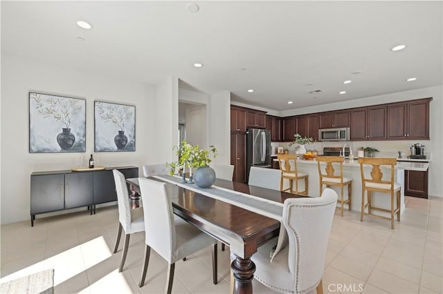 dining area with light tile patterned floors and recessed lighting