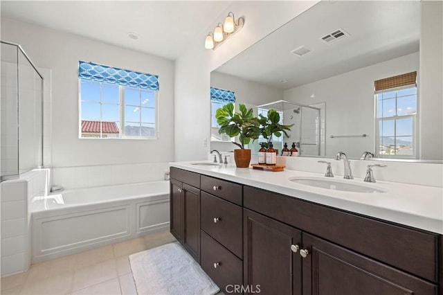 bathroom featuring a garden tub, tile patterned flooring, visible vents, a sink, and a stall shower
