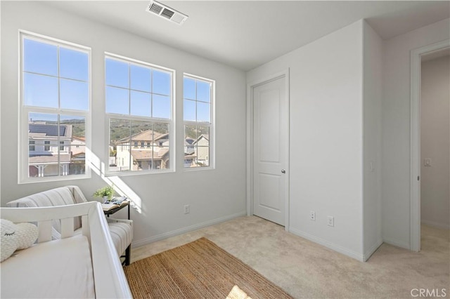 unfurnished bedroom featuring visible vents, baseboards, and carpet