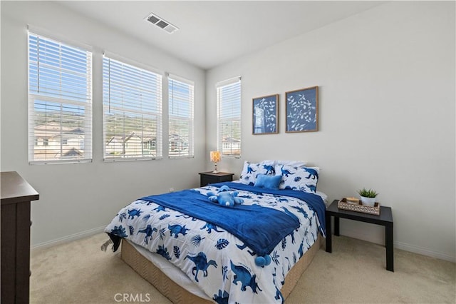 bedroom with carpet, visible vents, and baseboards